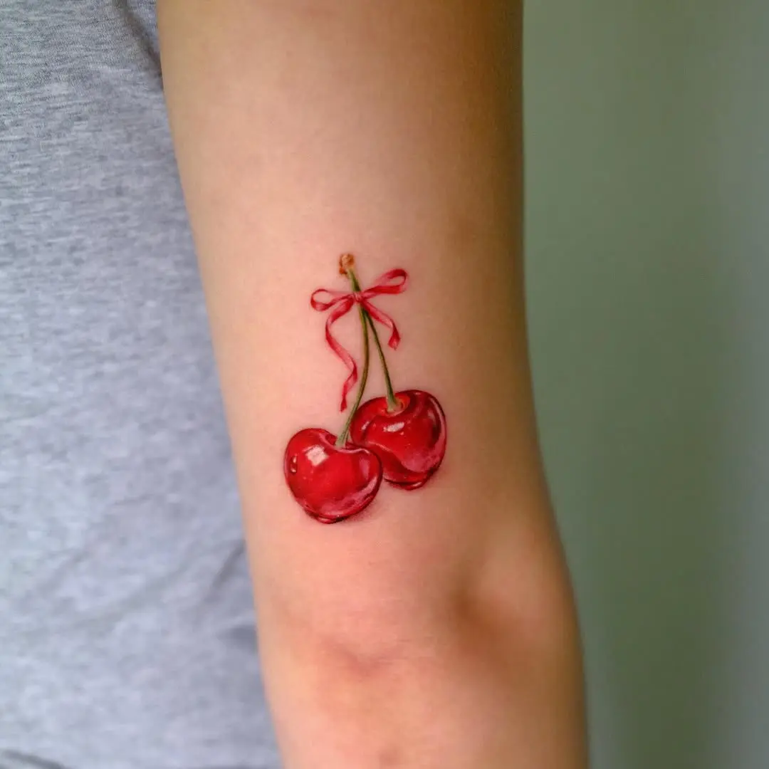 Charming Cherry Tattoo with Decorative Bow