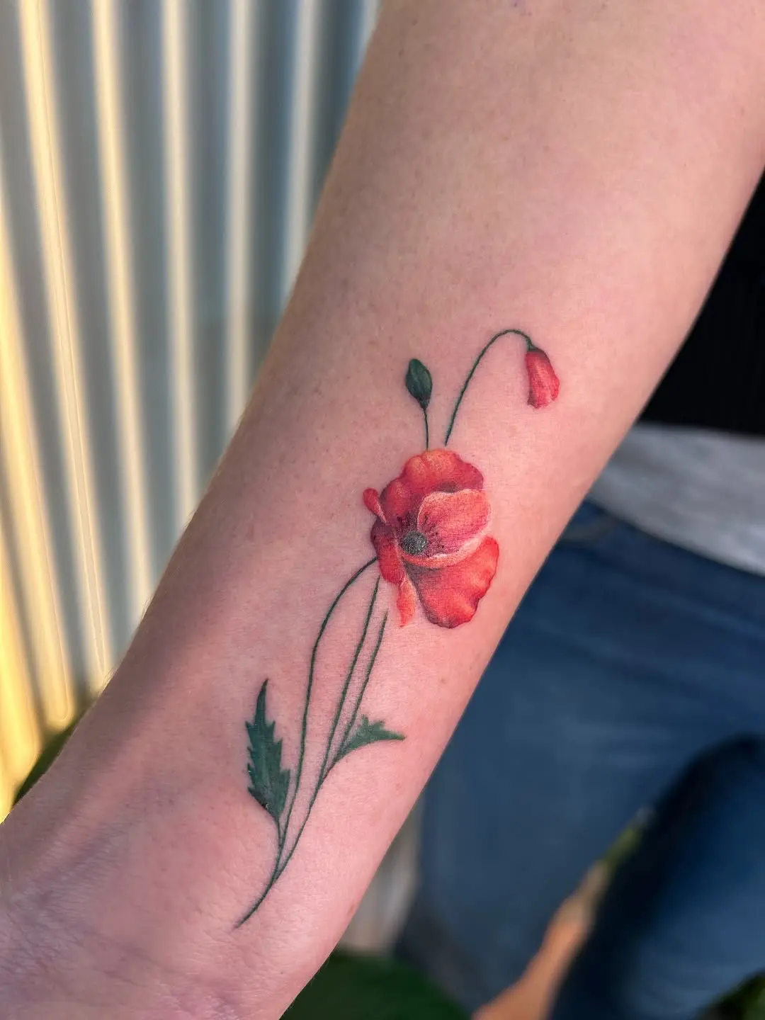 Stunning poppy tattoo with vibrant colors