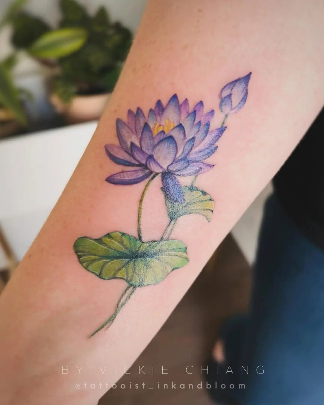 Elegant water lily tattoo showcasing vibrant colors