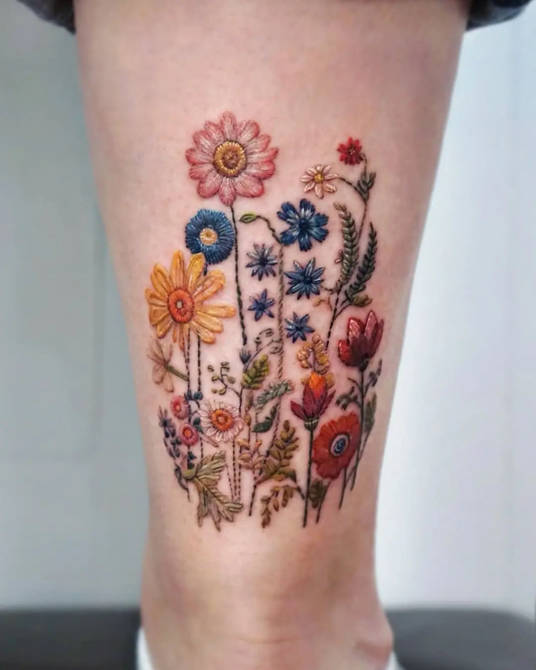 Colorful wildflower tattoo with intricate detailing
