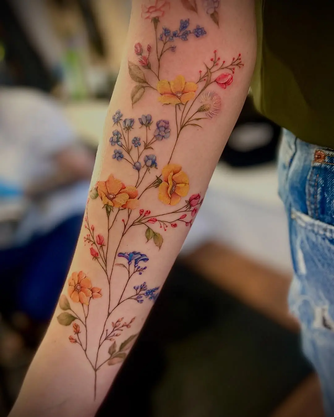 Stunning wildflower tattoo in vibrant colors