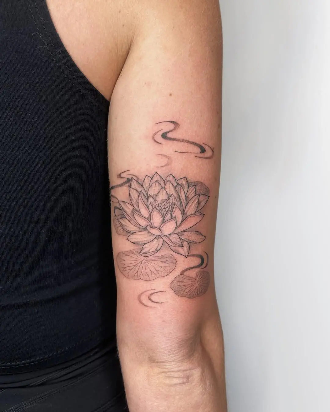 Elegant water lily tattoo design on the arm