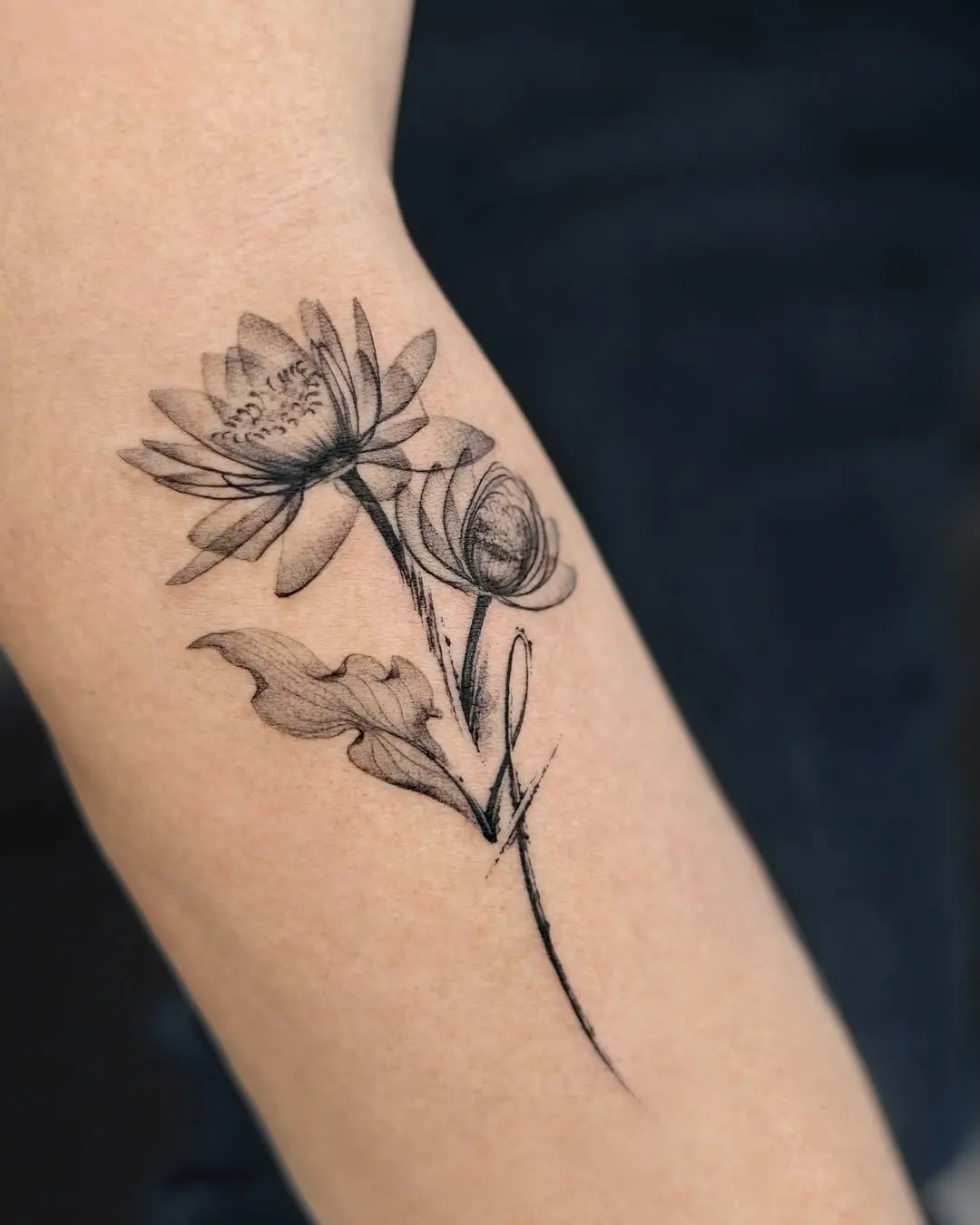 Elegant water lily tattoo with intricate details