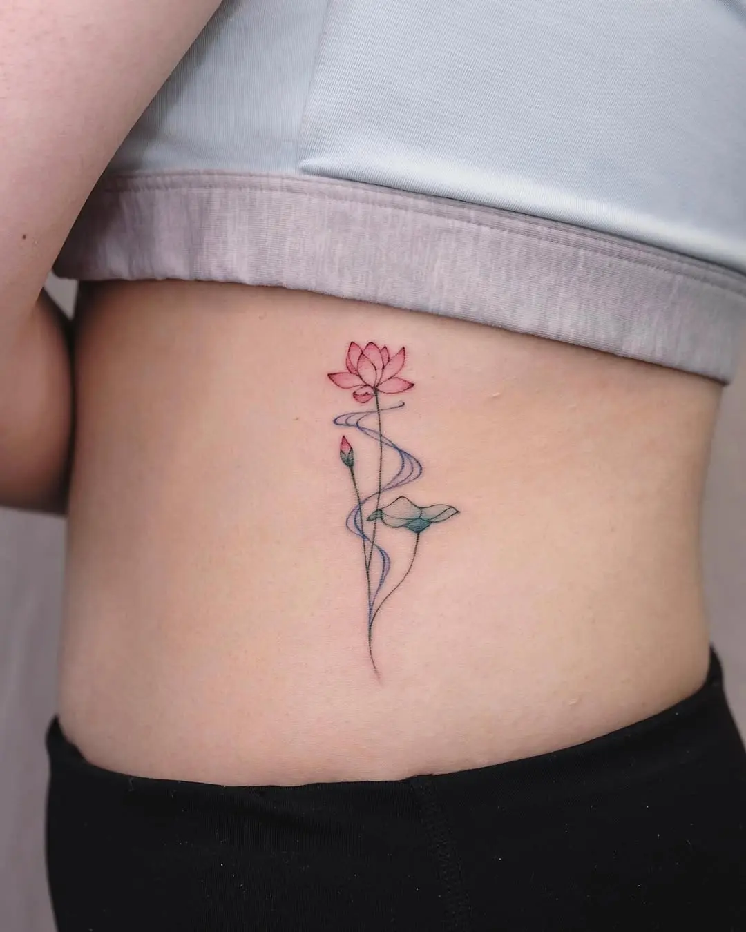 Delicate water lily tattoo on the side