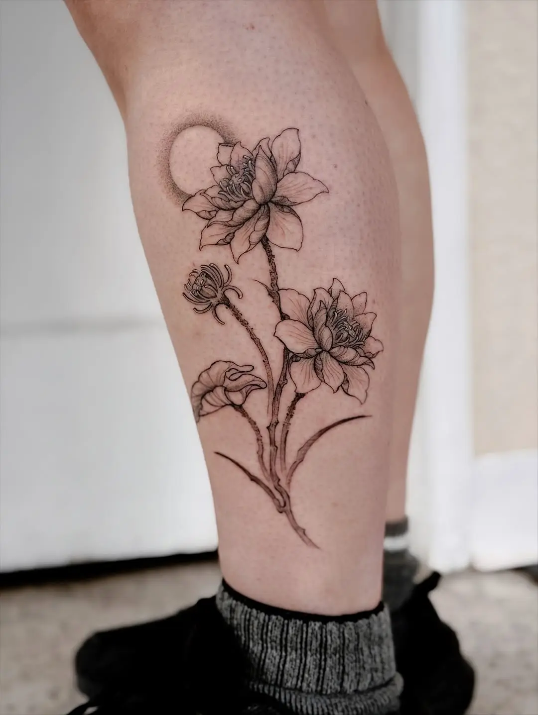 Intricate water lily tattoo showcasing nature's beauty