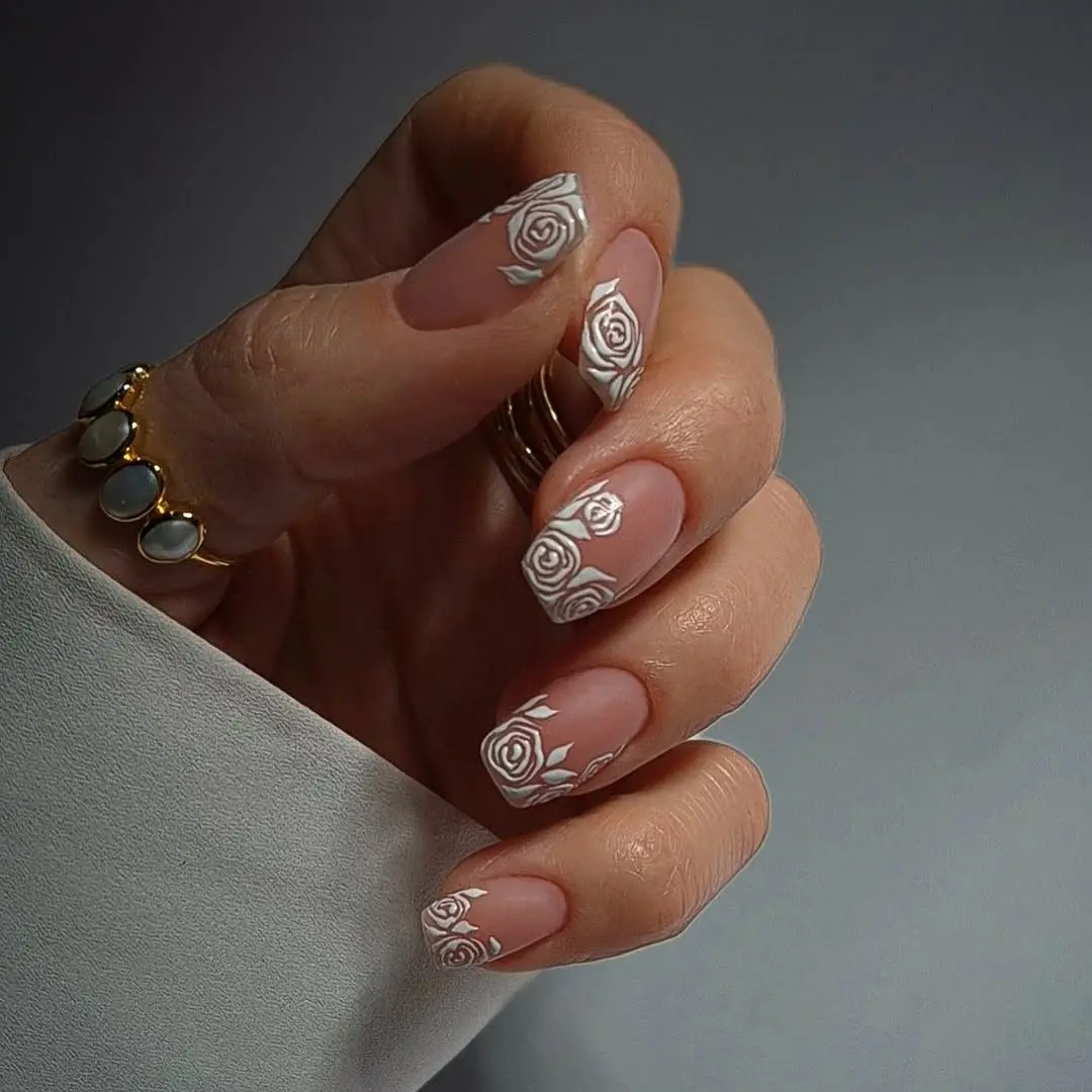 Elegant nude wedding nails with floral accents