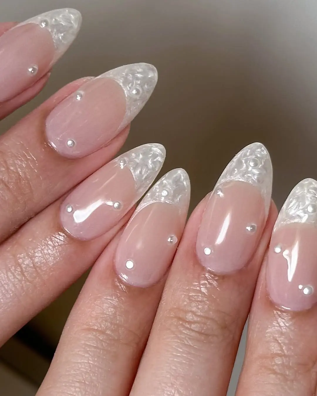 Elegant translucent wedding nail design with pearls