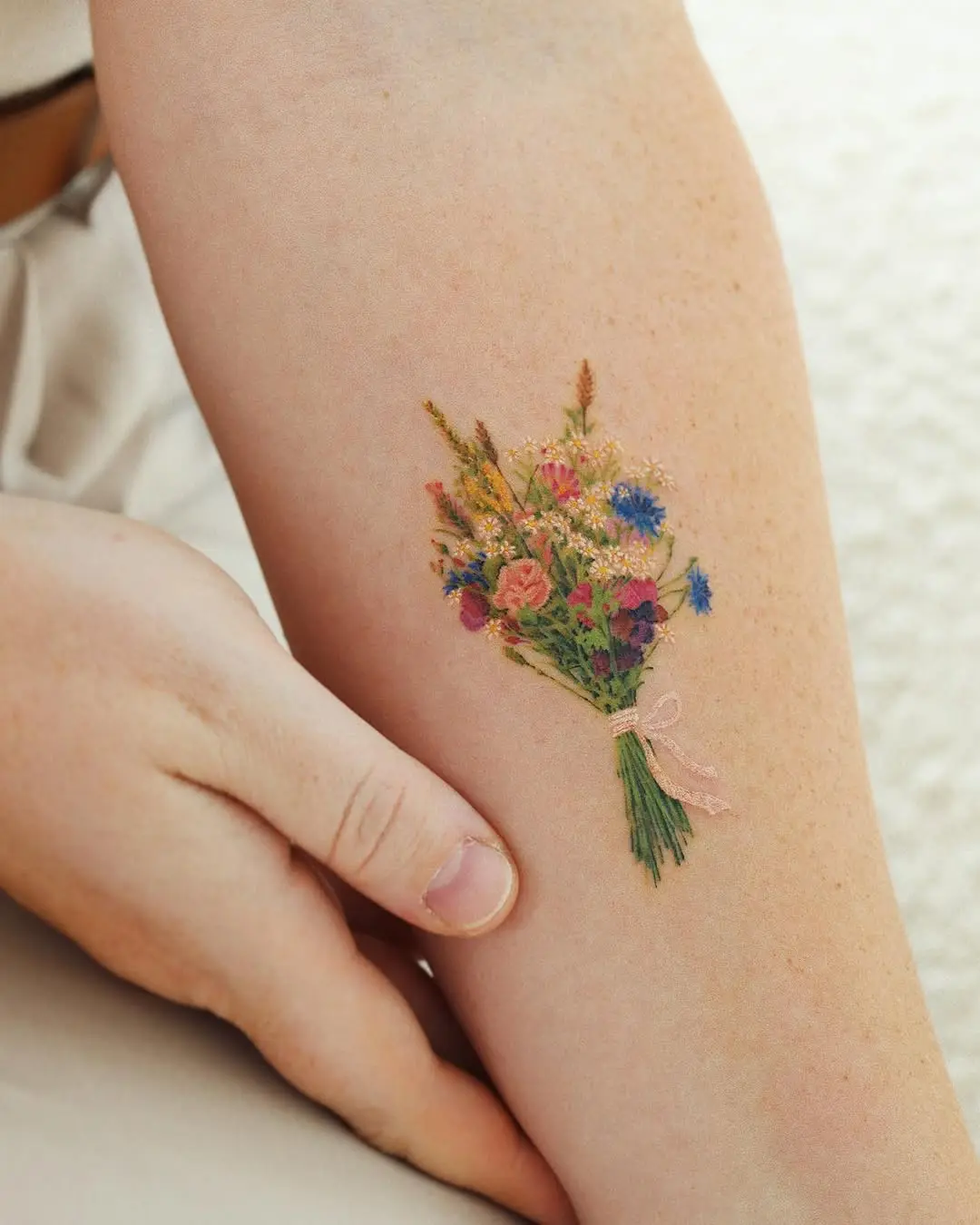 Charming bouquet tattoo adorning an arm