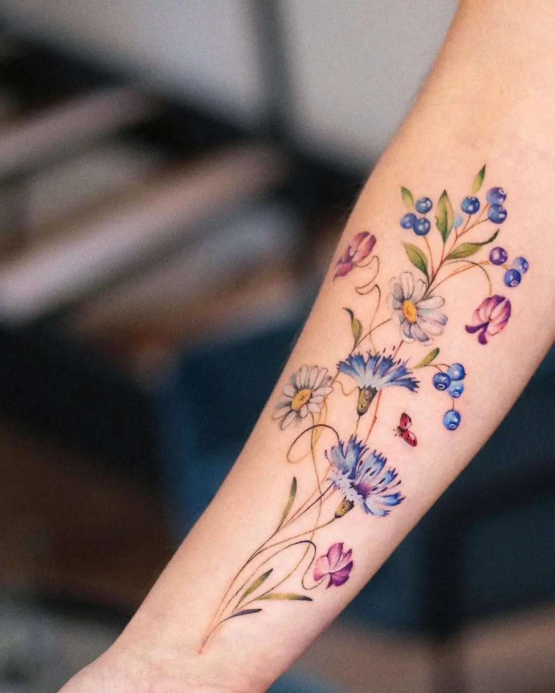 Vibrant wildflower tattoo with intricate details