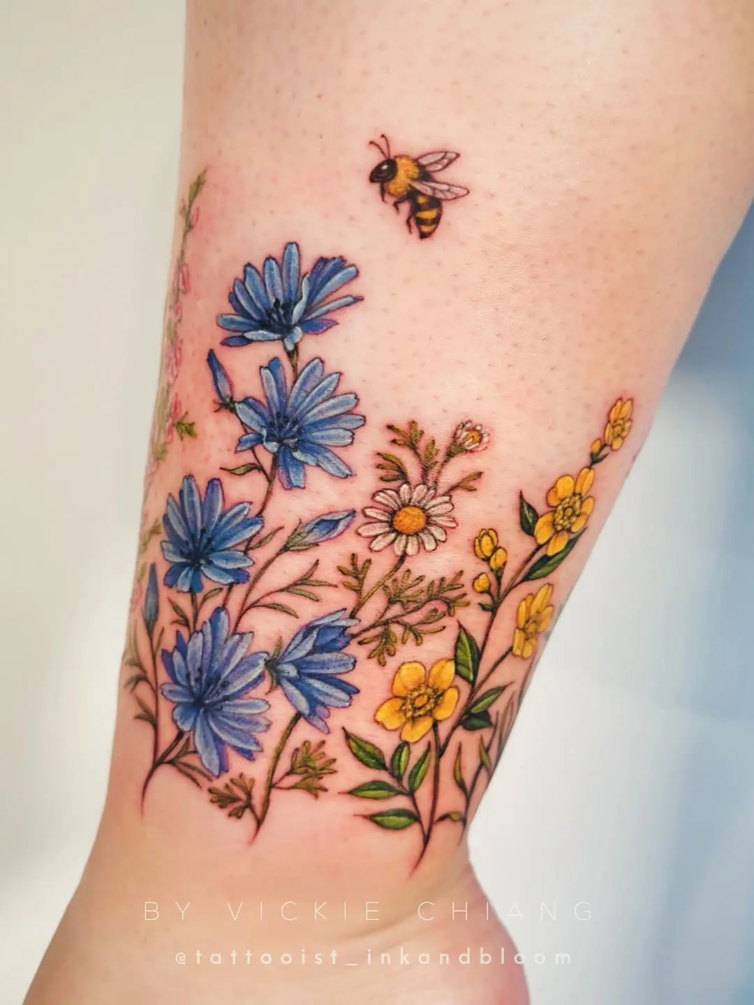 Vibrant wildflower tattoo featuring delicate details