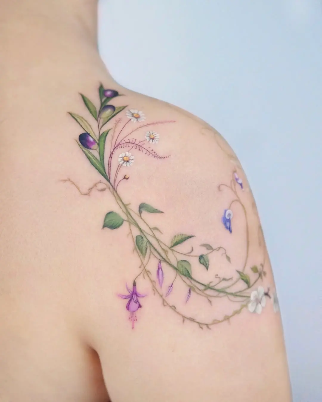 Elegant wildflower tattoo on shoulder