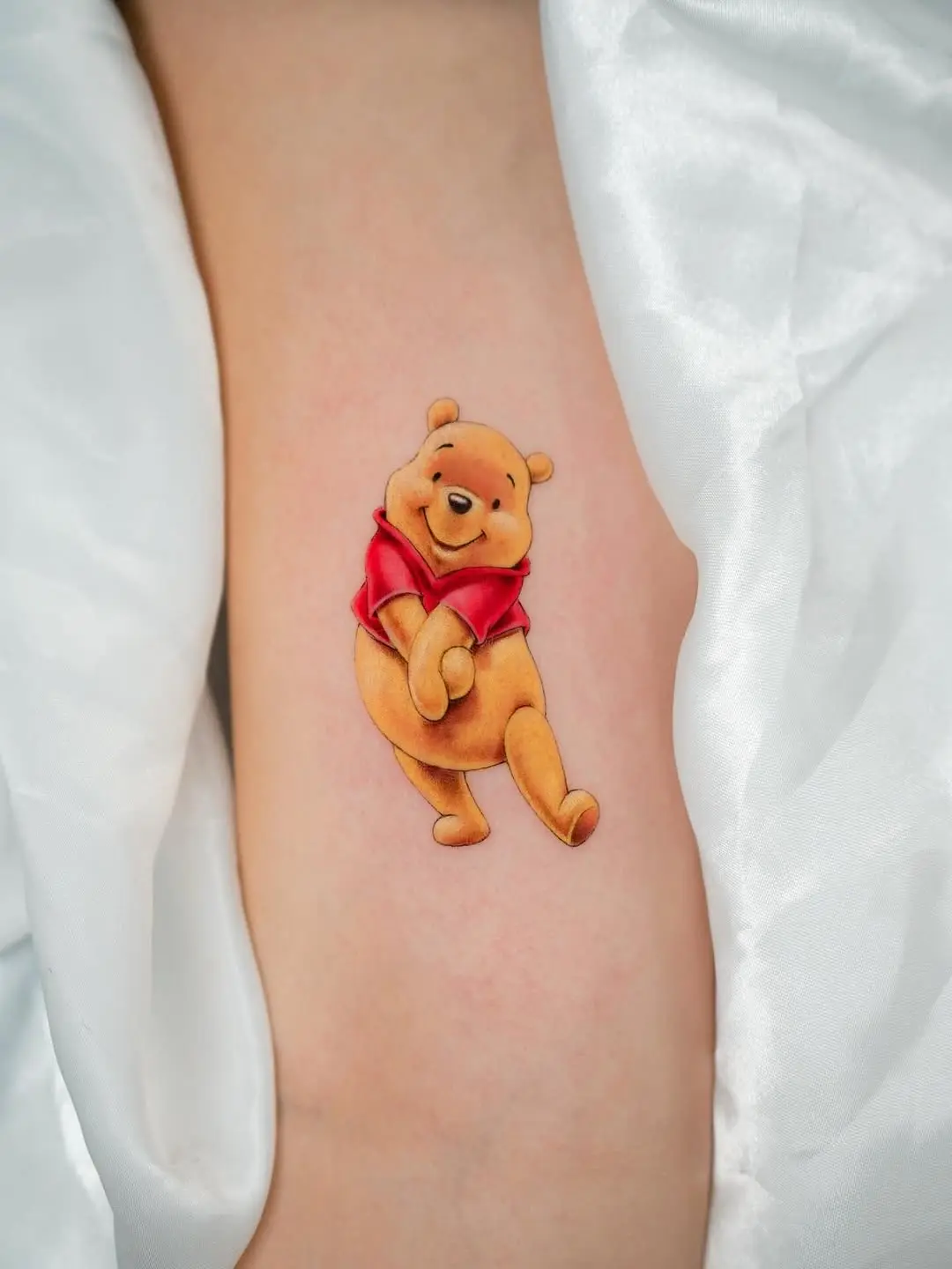 Playful Winnie the Pooh Tattoo on Skin