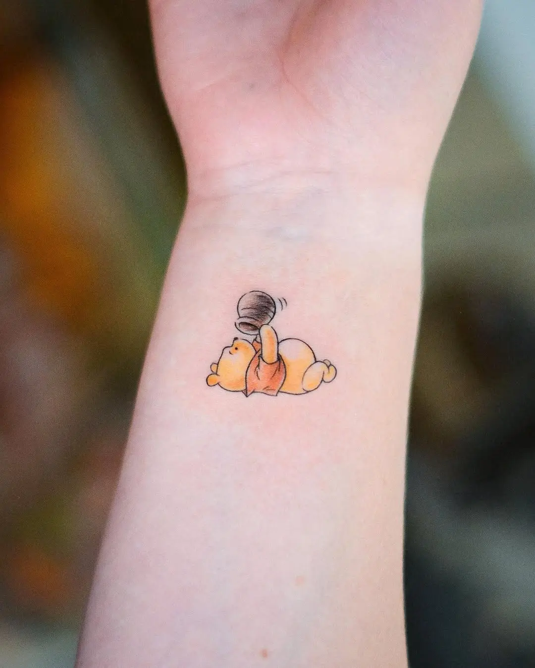 Adorable Winnie the Pooh Honey Tattoo Example