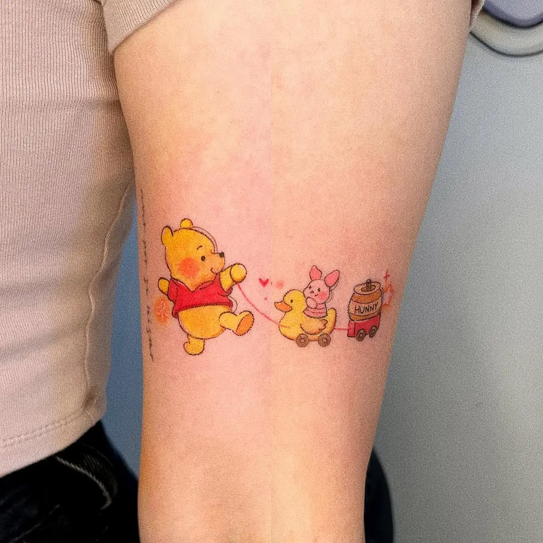 Playful Winnie the Pooh Tattoo with Friends