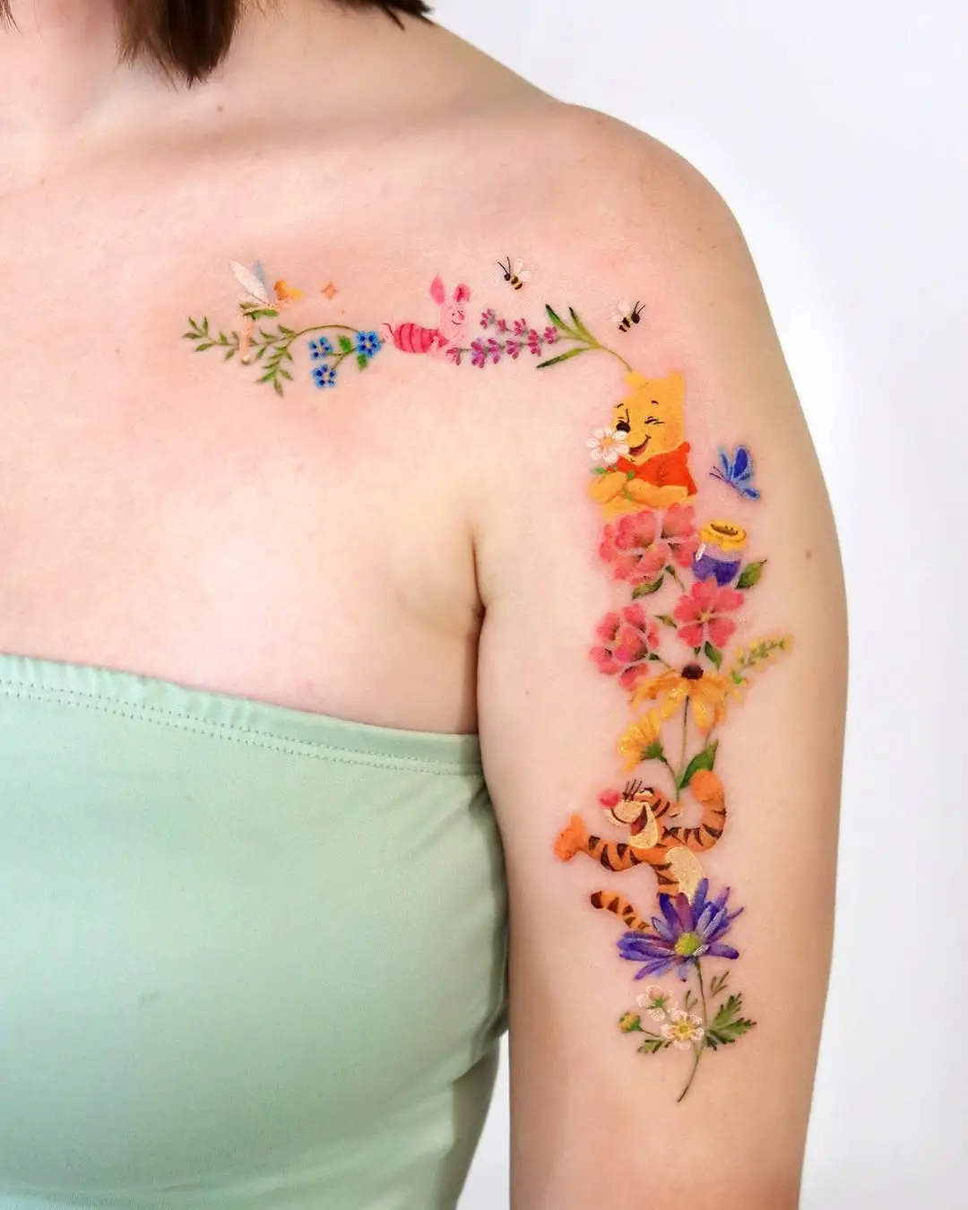Colorful Winnie the Pooh Floral Arm Tattoo