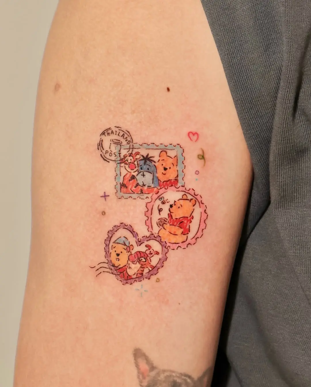 Charming illustrated Pooh bear stamp tattoos