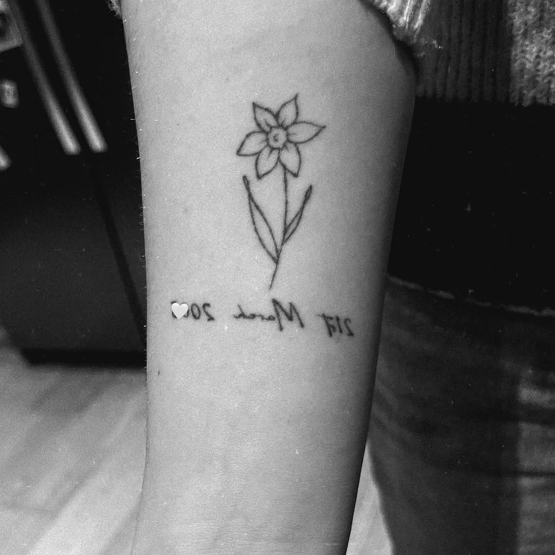 Delicate flower tattoo with significant date