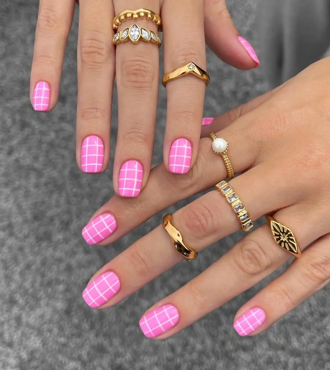 Chic Pink Grid Nails with Glamorous Rings