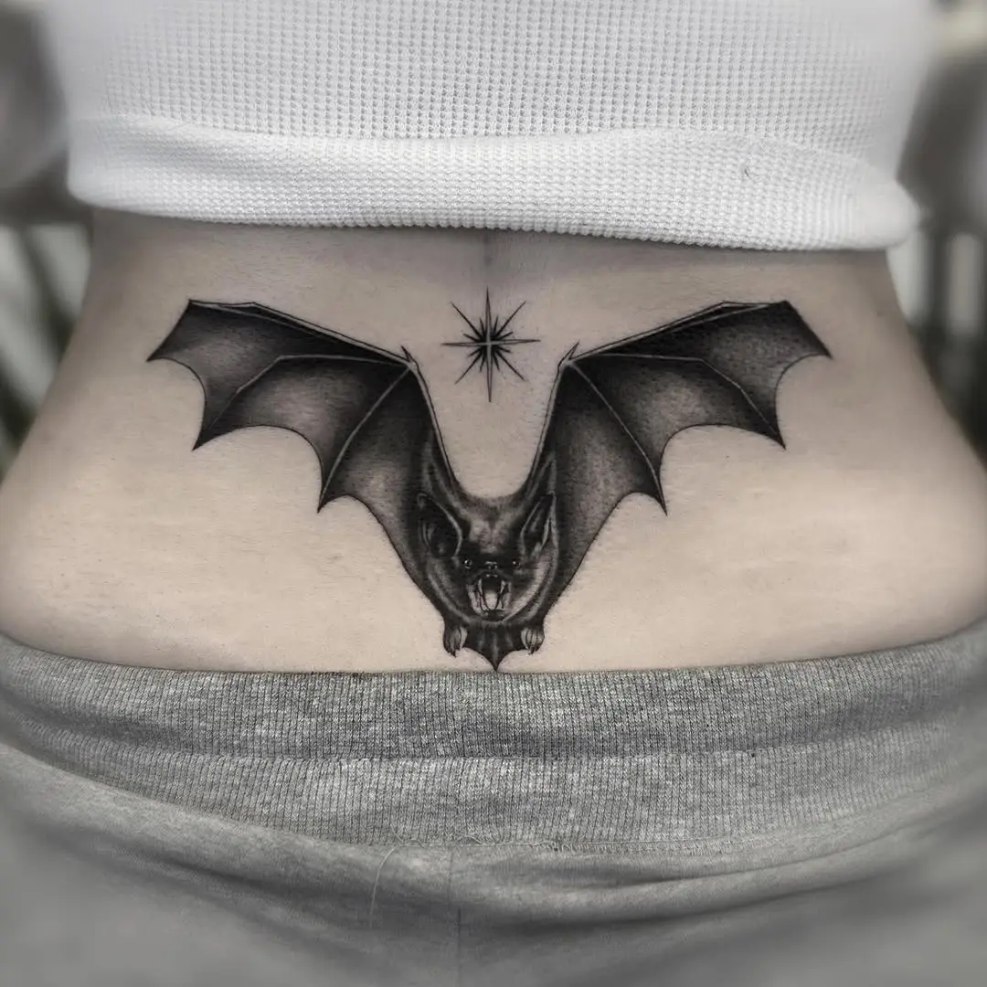 Striking bat tattoo with celestial details