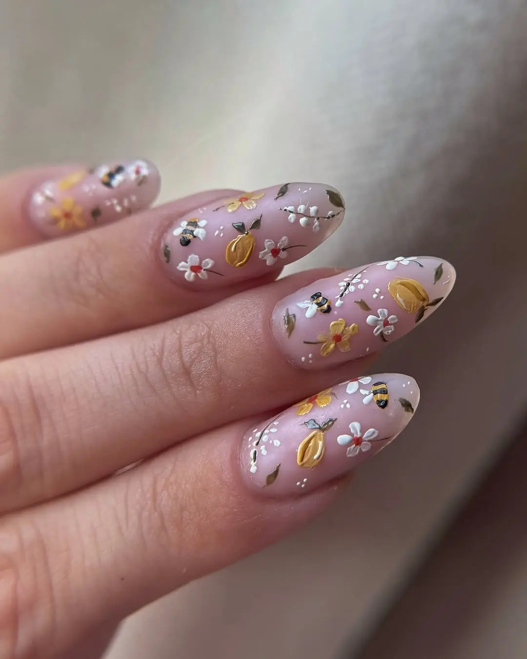 Charming bee-themed floral nail art design
