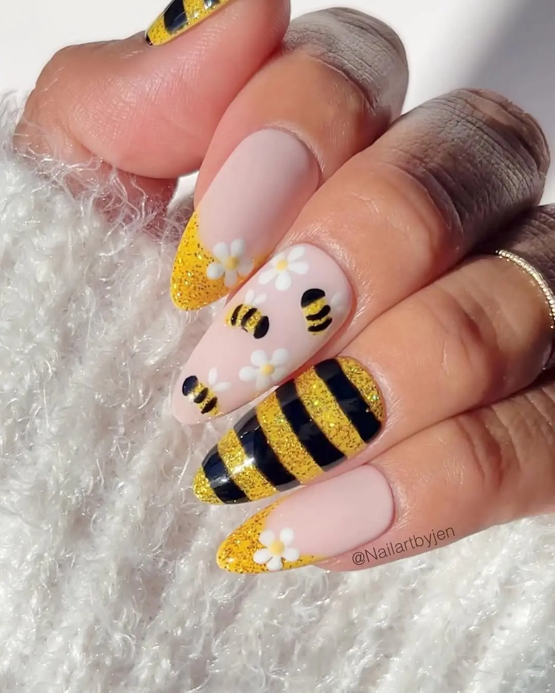 Vibrant bee-inspired nail art with glitter accents