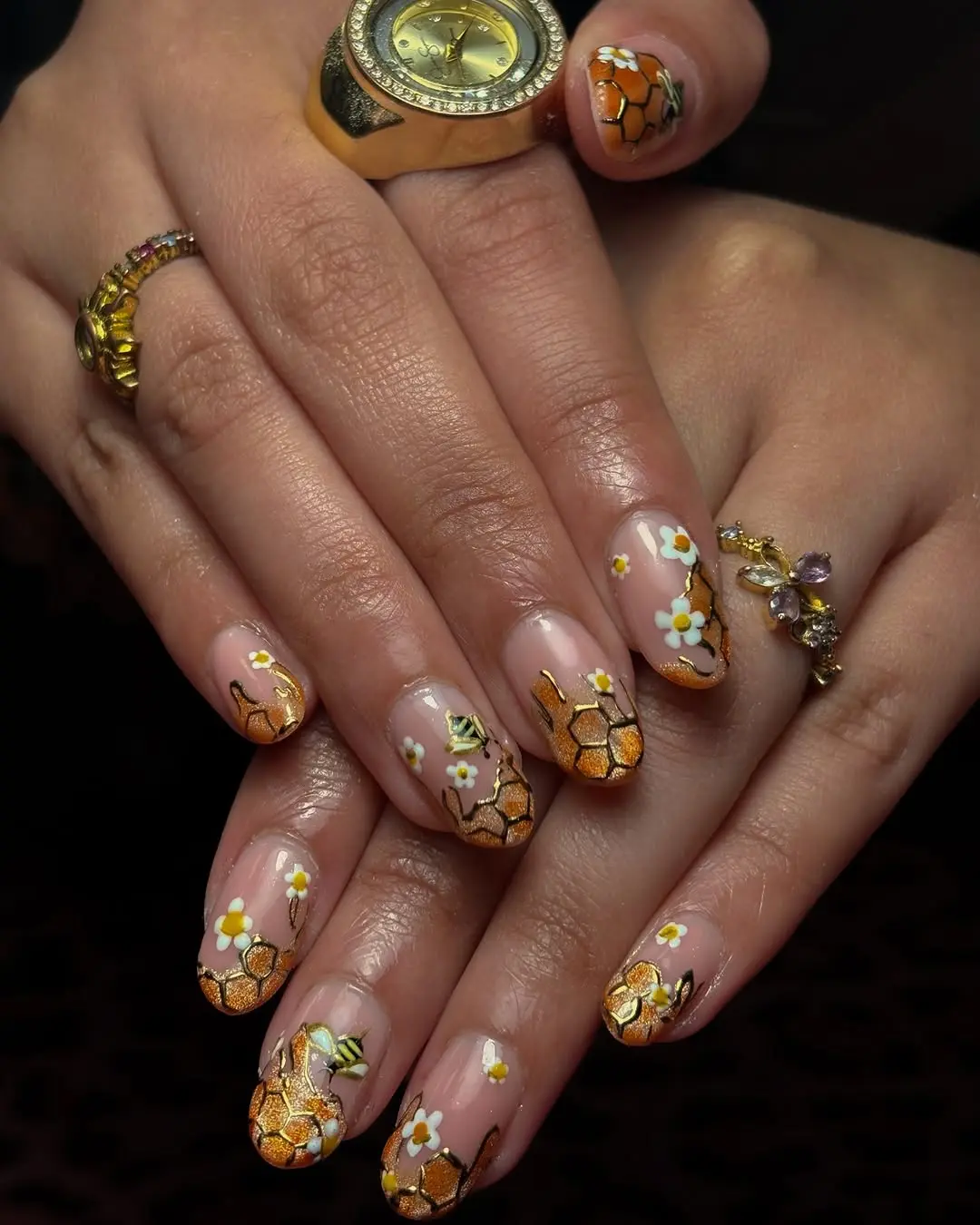 Charming bee-themed nail art creation.