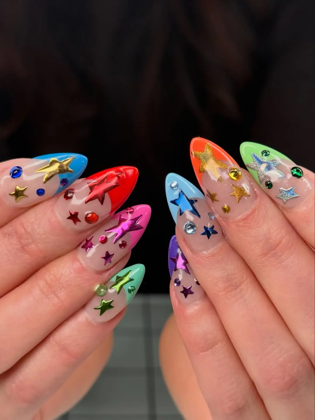 Vibrant birthday nails with colorful star accents