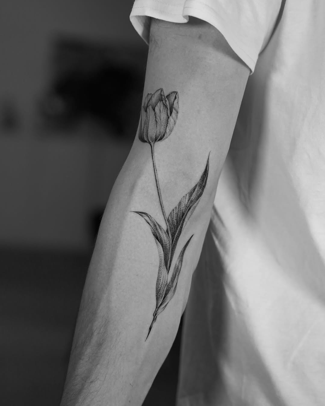 Elegant tulip tattoo on a man's arm
