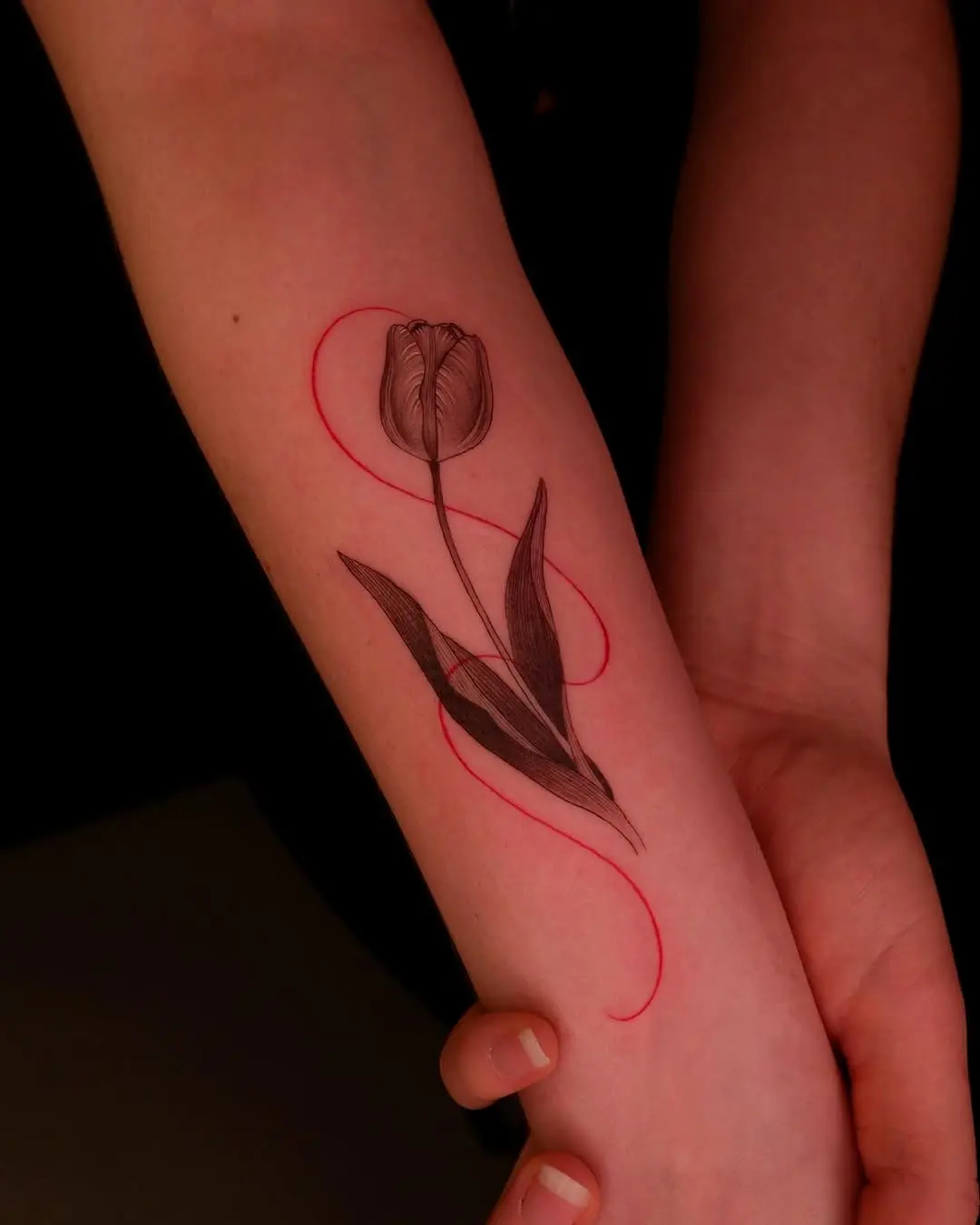 Elegant tulip tattoo with vibrant red accents