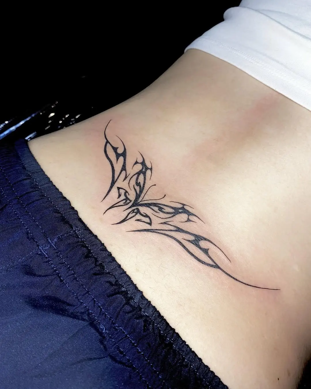 Elegant butterfly tattoo on lower back