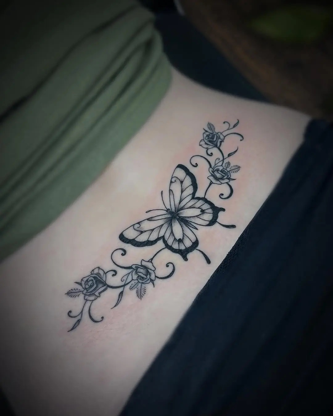Elegant butterfly with floral accents tattoo design