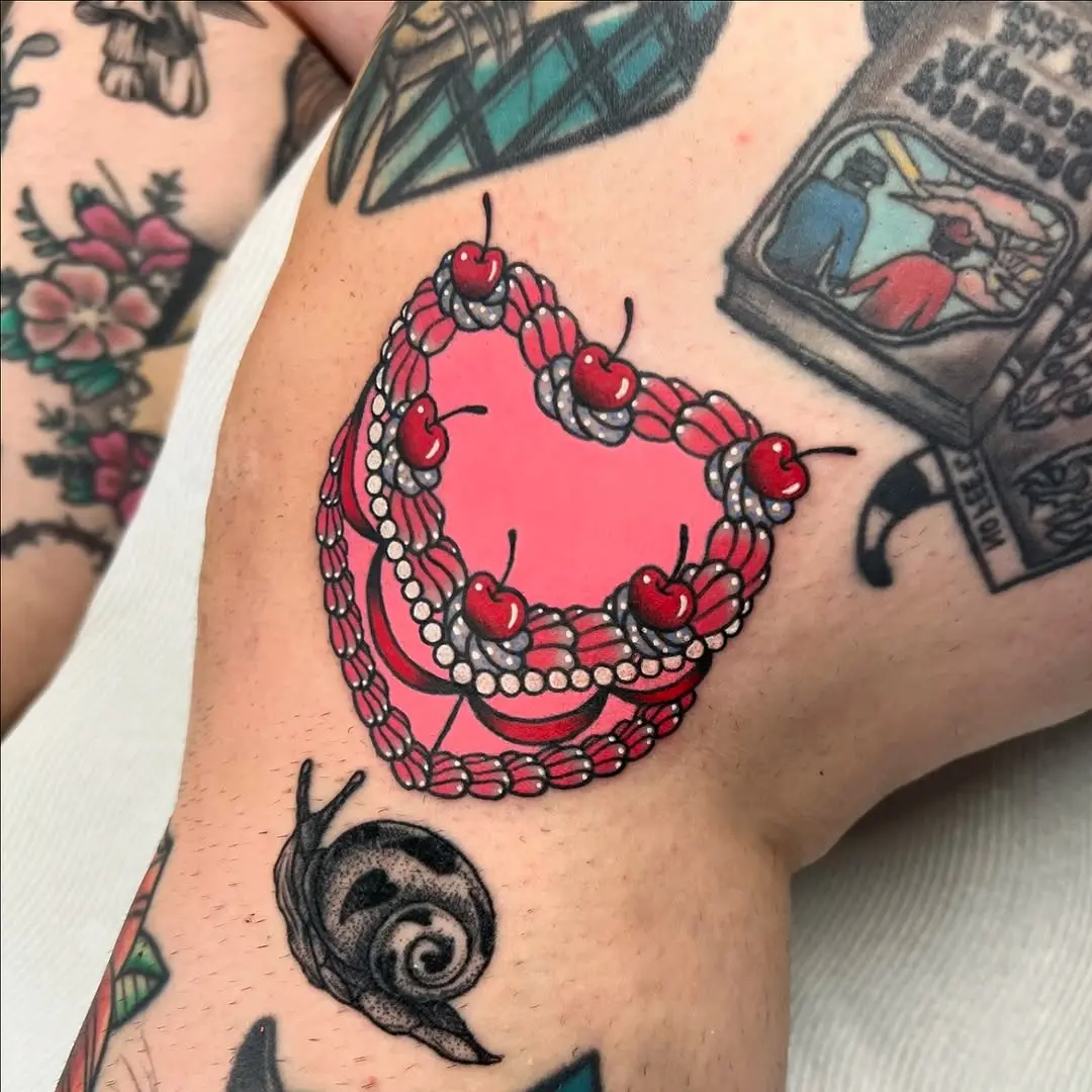 Vibrant cake tattoo with playful cherry details