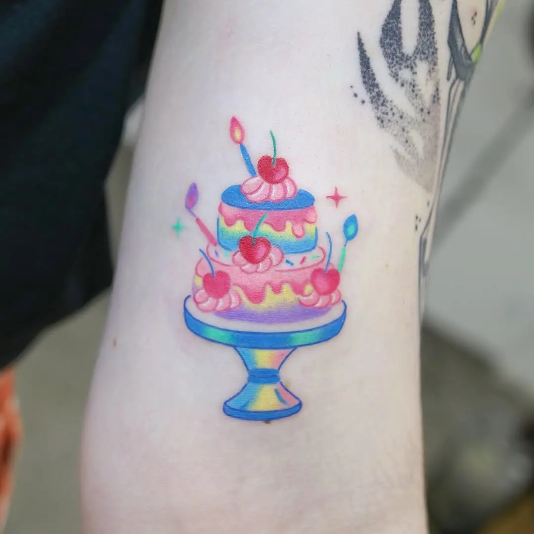 Delightful cake tattoo with vibrant pastel colors