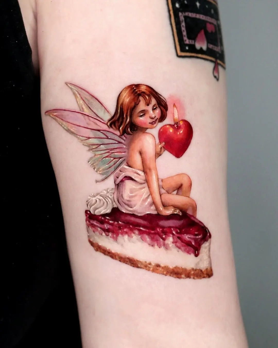 Whimsical fairy-themed cake tattoo design