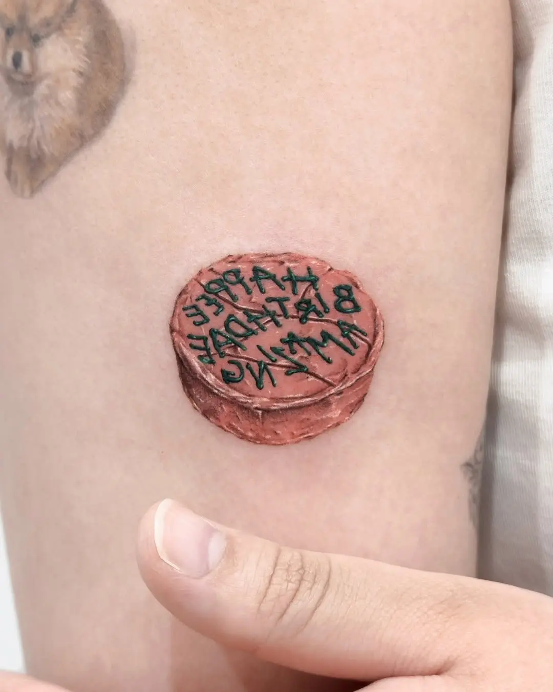 Intricate cake tattoo with personalized inscription