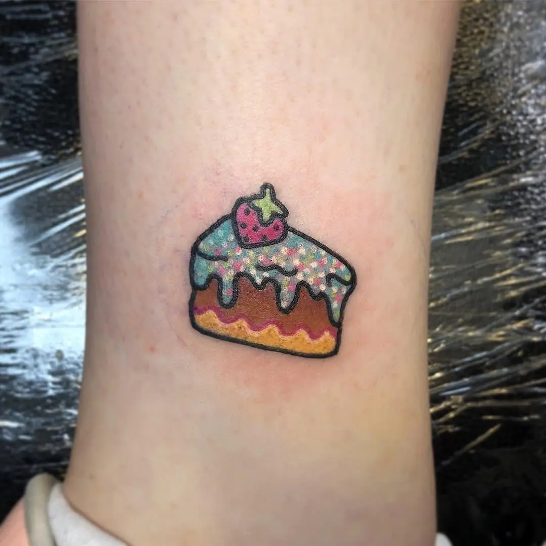 Colorful cake tattoo with a playful vibe
