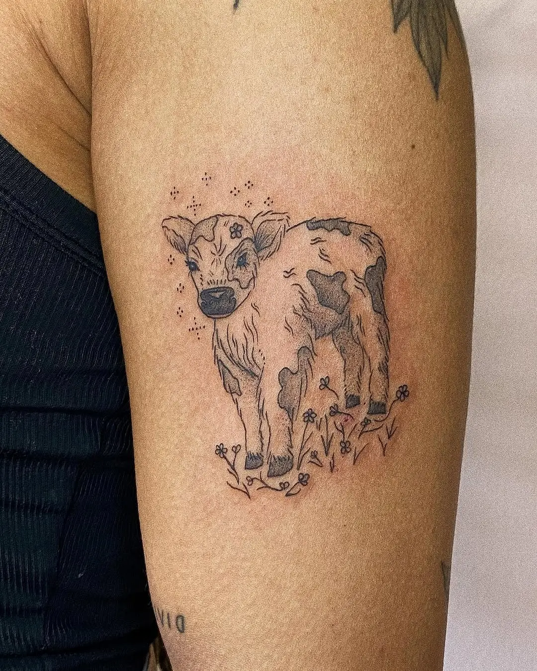 Charming calf tattoo with floral accents