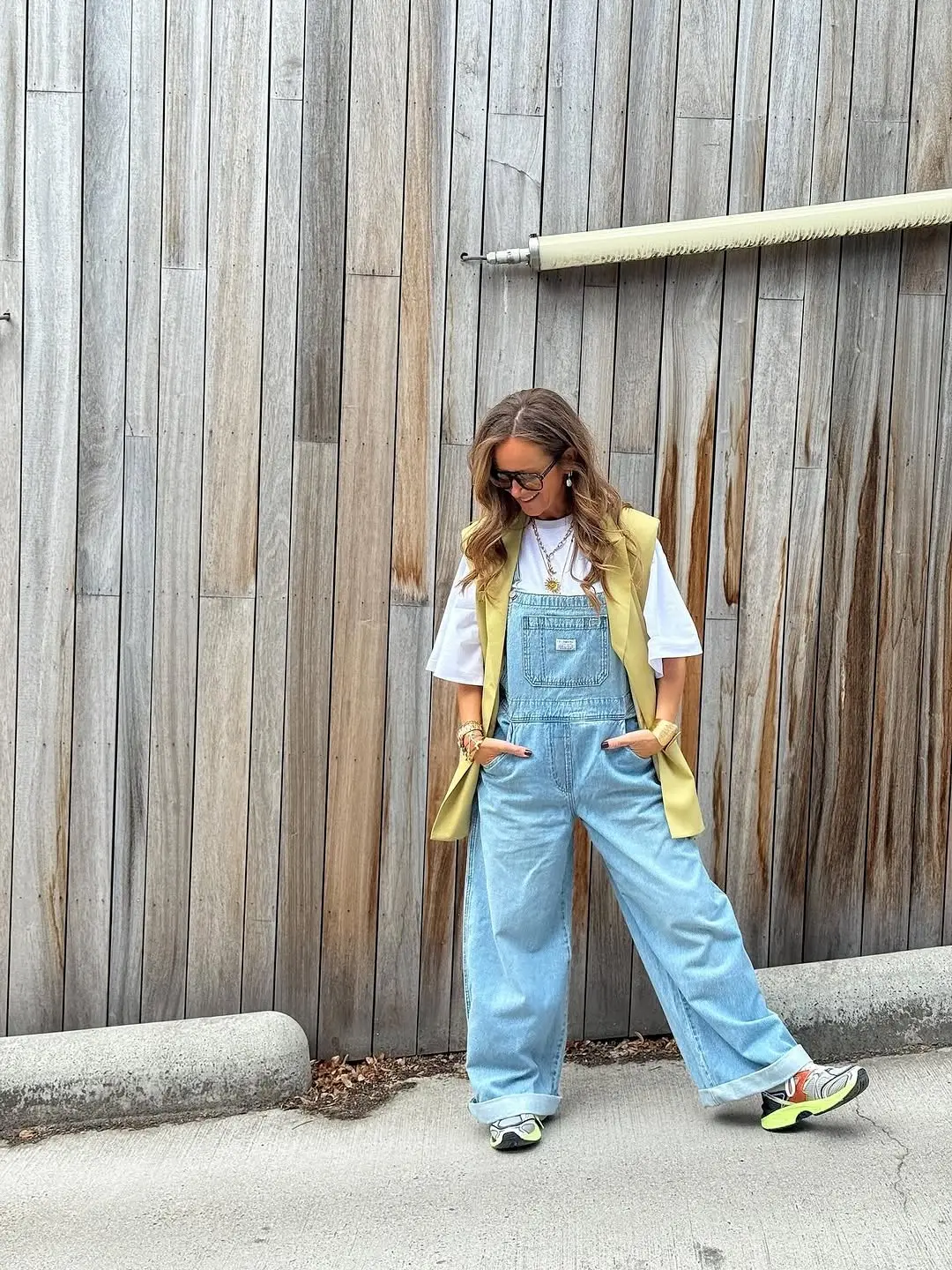 Stylish overalls layered with a chic vest