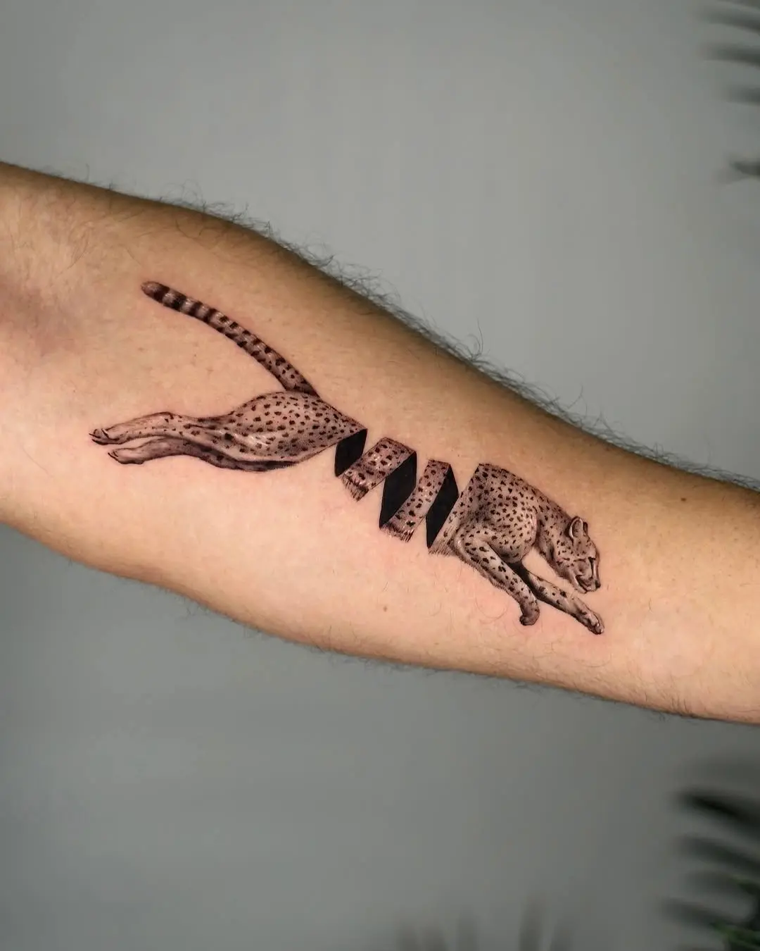 Dynamic cheetah mid-leap tattoo design