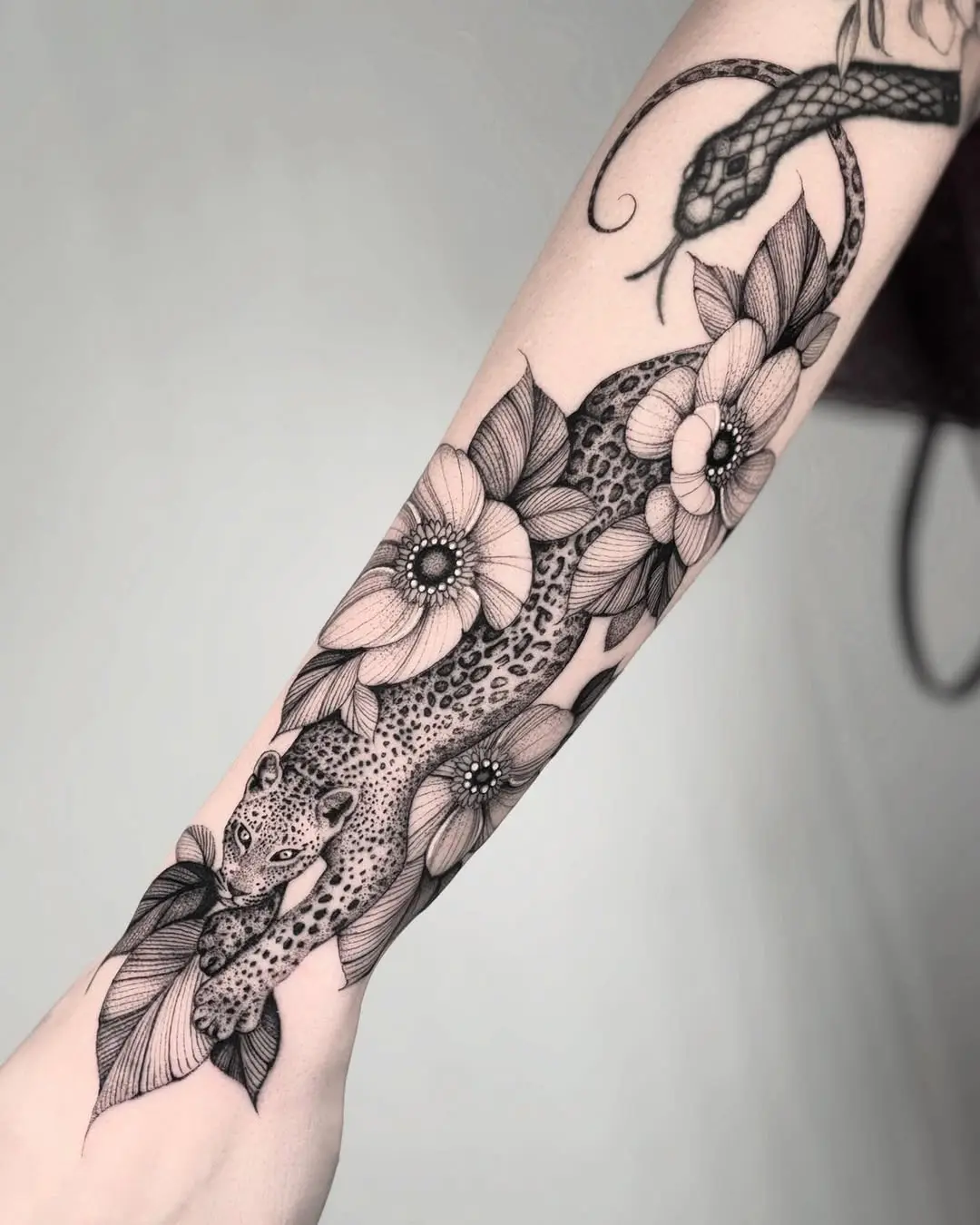 Elegant Cheetah Tattoo Among Blooming Flowers