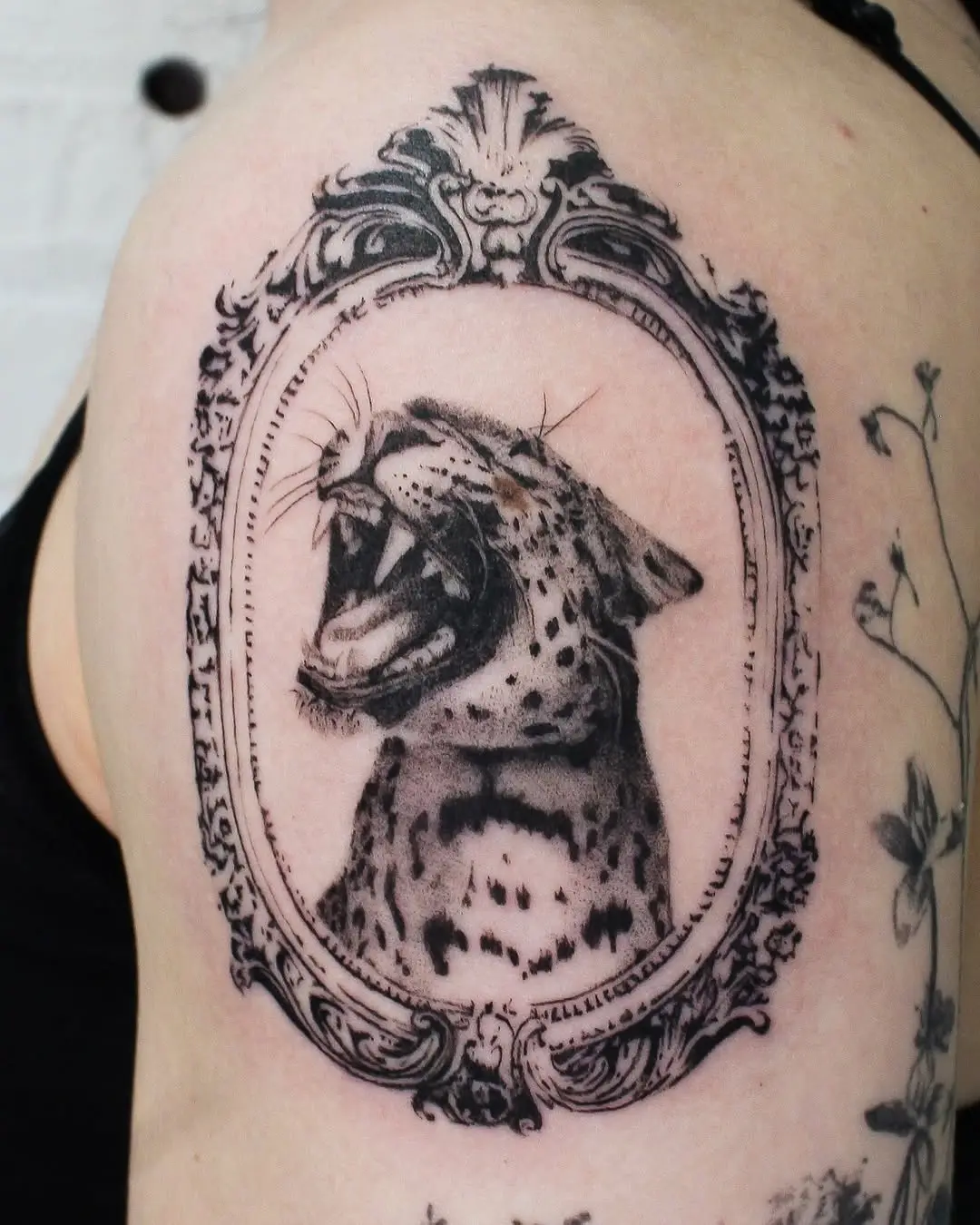 Elegant framed cheetah tattoo exudes ferocity