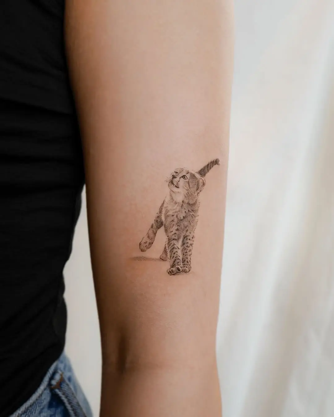 Playful Cheetah Tattoo on Arm