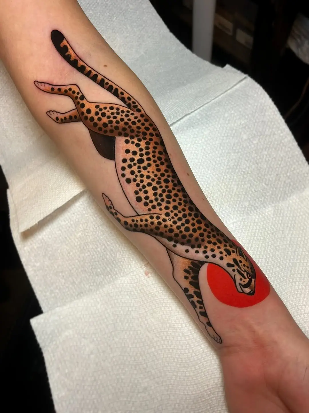 Dynamic cheetah tattoo with vibrant colors