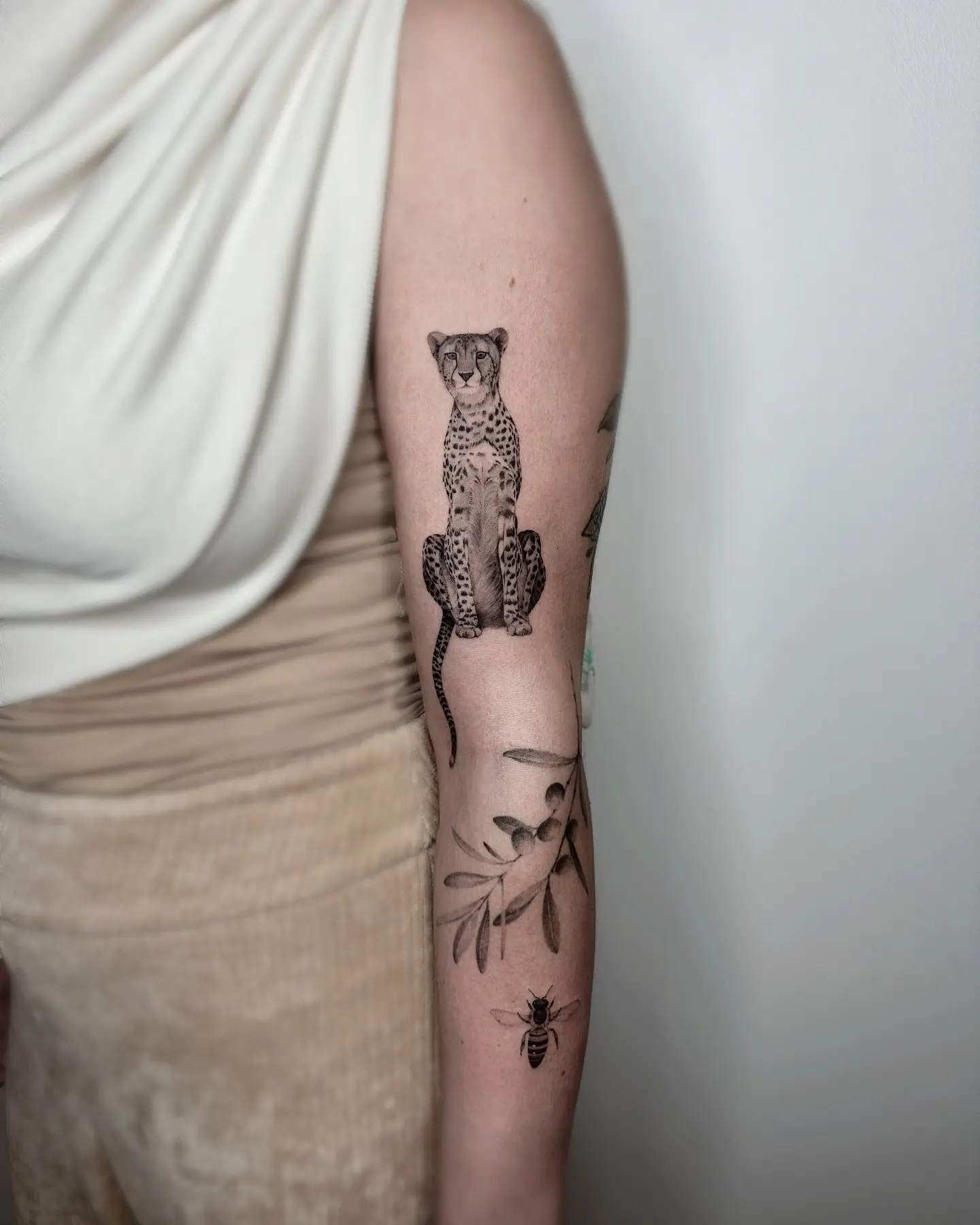 Stylish cheetah tattoo on the arm