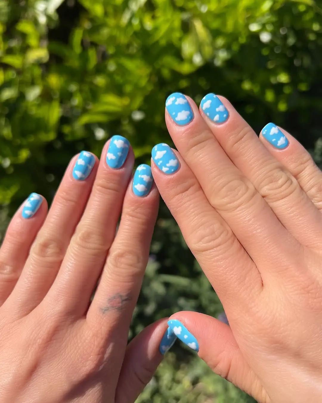 Whimsical blue cloud nails for a cheerful vibe