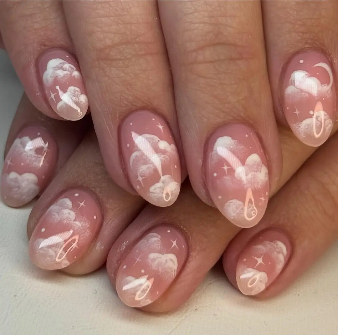 Dreamy cloud nail art with starry accents
