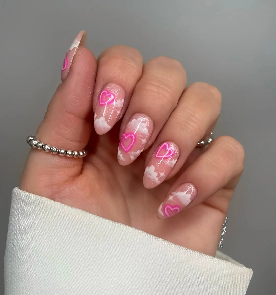 Charming cloud nails with playful heart accents