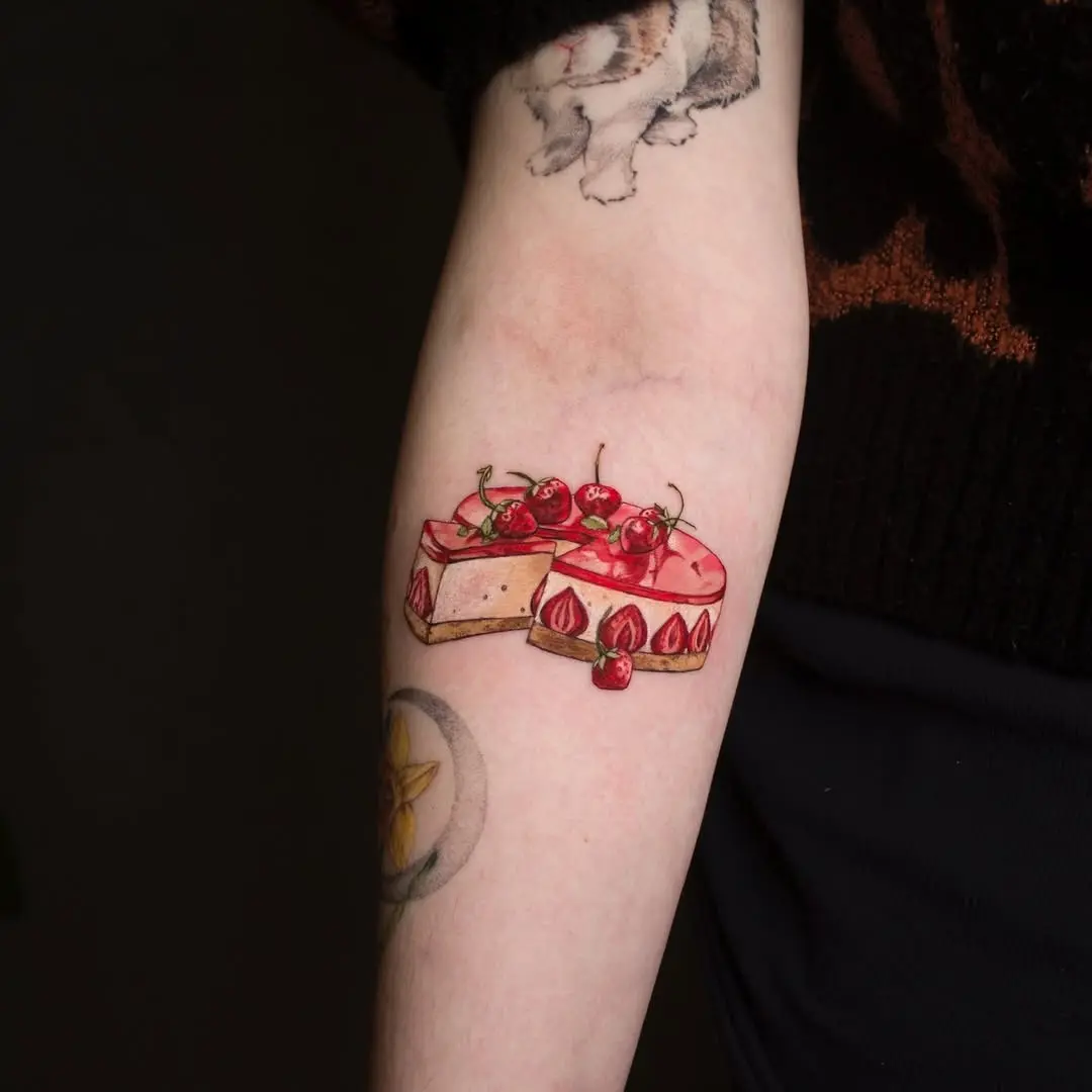 Delightful cake tattoo with vibrant cherries