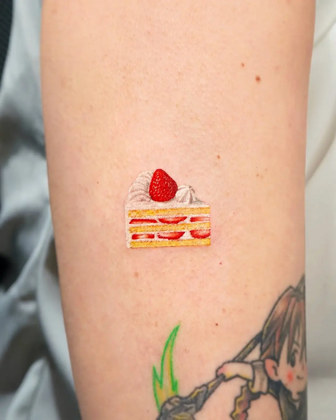Deliciously vibrant cake tattoo design
