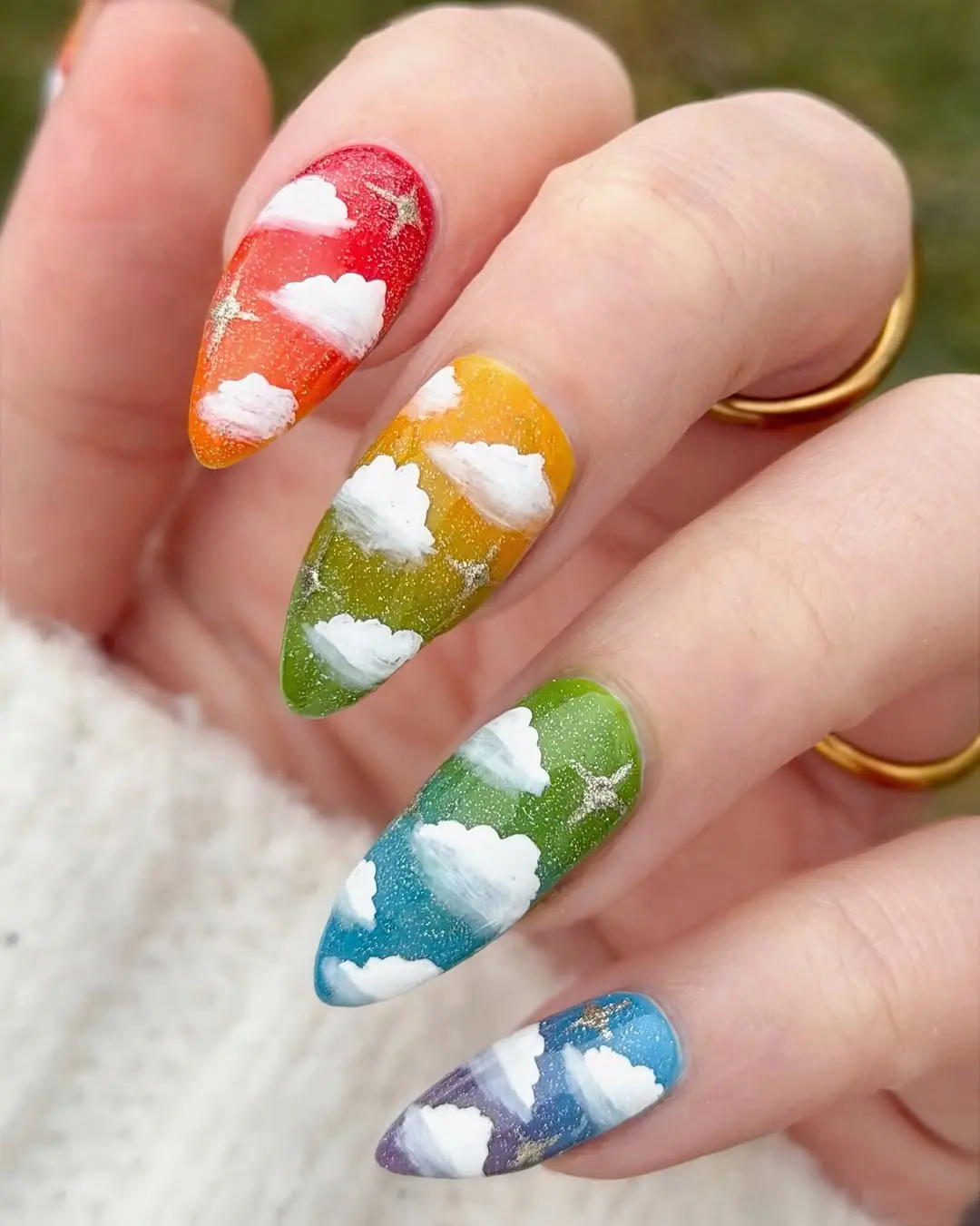 Vibrant nails featuring whimsical cloud designs